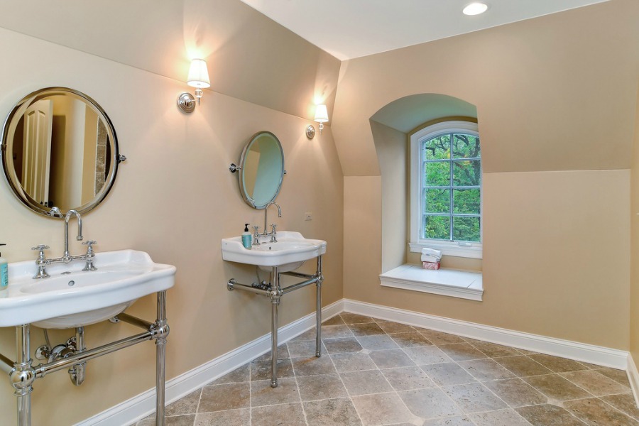 Double console sinks in a French country bathroom.