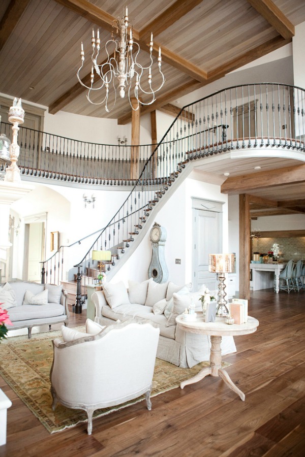 Magnificent French country living room with dramatic wrought iron staircase - Decor de Provence.