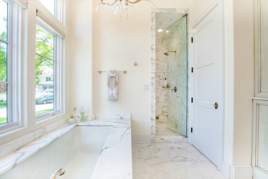 Luxurious white marble surround on a bathtub in a French country home.