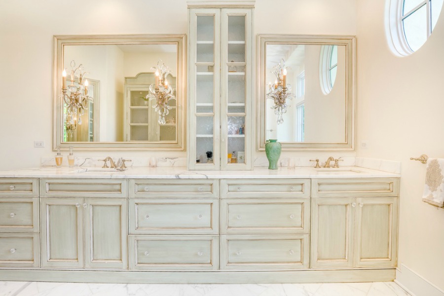 Luxurious and timeless bathroom design with glazed pale cabinetry and white marble.