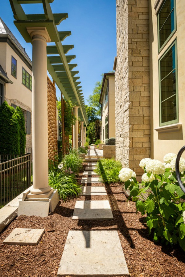 Landscaping detail with mulch, pavers, and hydrangea outside a grand French home in Elmhurst, IL.