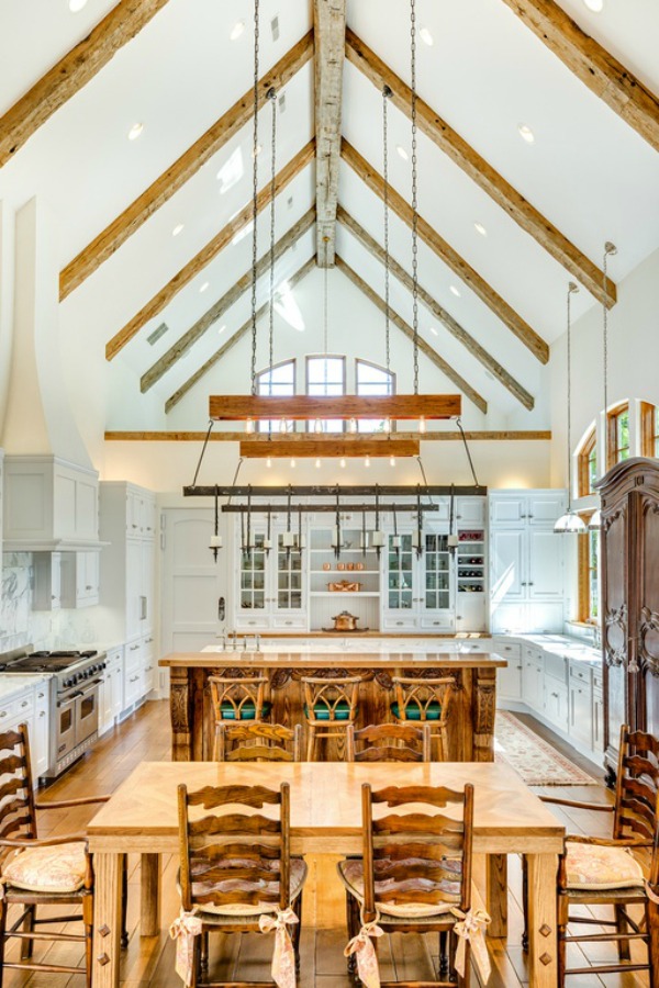 Magnificent lofty ceiling in a kitchen of a French country home with an abundance of warm natural wood and white cabinetry. Realistic Country French Decor from Luxurious Ideas...certainly lovely indeed. Decorating ideas for French country style rooms as well as shopping resources.