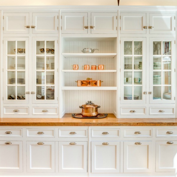 Magnificent custom white Shaker cabinetry in a French kitchen with wood countertops and copper accents. Located in Elmhurst IL.