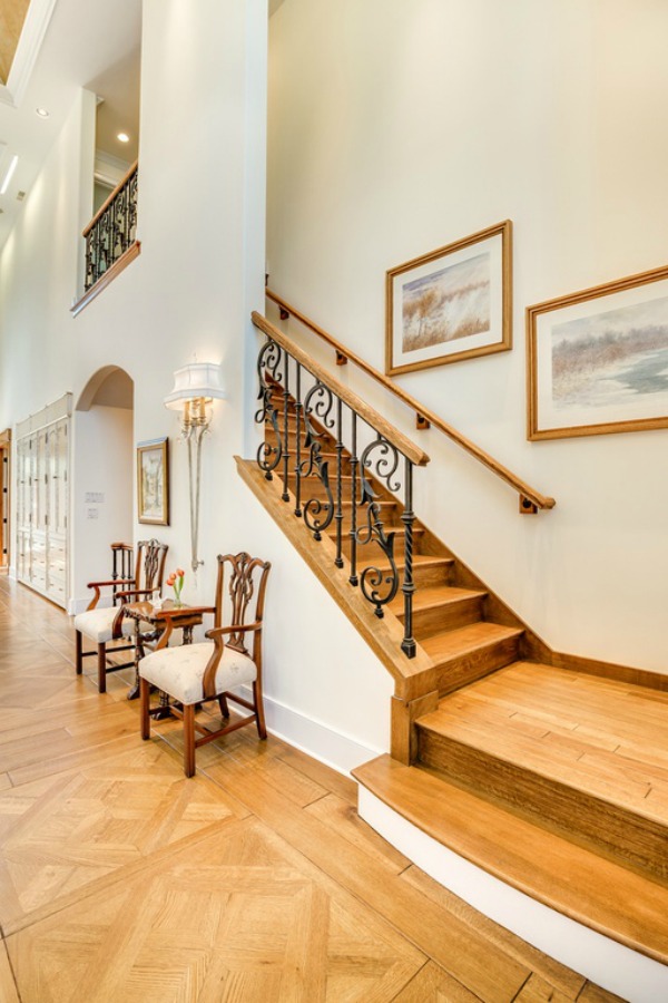 Beautiful oak hardwood flooring in an entry and stairs in a grand French country house in Elmhurst, IL.