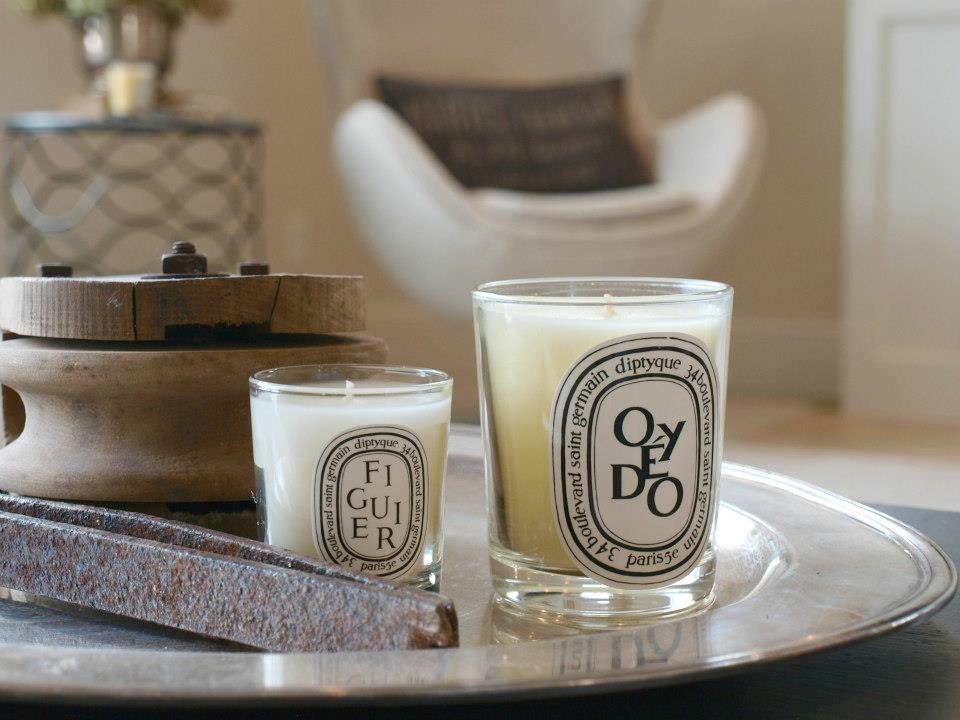 A silver tray with rustic objects and Diptyque candles in our Belgian style living room. Hello Lovely Studio. Come discover more inspiring trays for layering and vignettes in Adding Tray Très Chic to Your Home.