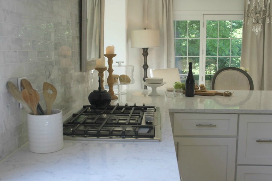 Hello Lovely Studio. My white kitchen with Viatera quartz countertop (Minuet), polished marble subway tile backsplash, Bosch appliances, farm sink, and Shaker cabinets.
