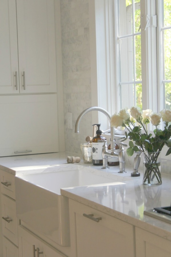 Hello Lovely Studio. My white kitchen with Viatera quartz countertop (Minuet), polished marble subway tile backsplash, Bosch appliances, farm sink, and Shaker cabinets.