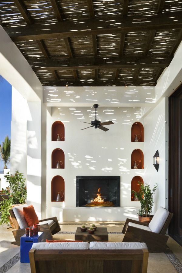 Luxurious loggia with fireplace and arches by Ike Kligerman Barkley