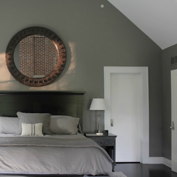 Serene and minimal interior design inspiration from an industrial farmhouse style bedroom with Benjamin Moore Platinum Gray paint color on walls. Photo: Hello Lovely Studio.