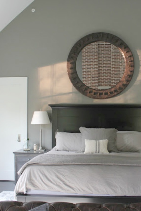 Serene and minimal interior design inspiration from an industrial farmhouse style bedroom with Benjamin Moore Platinum Gray paint color on walls. Photo: Hello Lovely Studio.