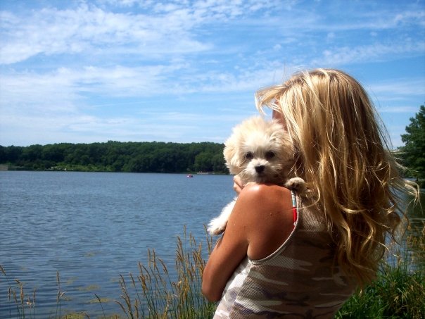 Michele of Hello Lovely Studio at lake with white puppy.