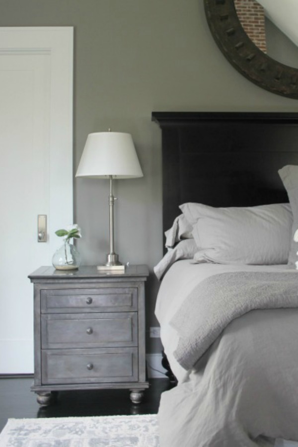 Serene and minimal interior design inspiration from an industrial farmhouse style bedroom with Benjamin Moore Platinum Gray paint color on walls. Photo: Hello Lovely Studio.