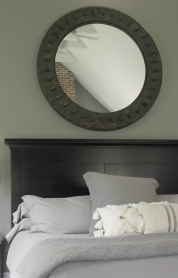 Serene and minimal interior design inspiration from an industrial farmhouse style bedroom with Benjamin Moore Platinum Gray paint color on walls. Photo: Hello Lovely Studio.