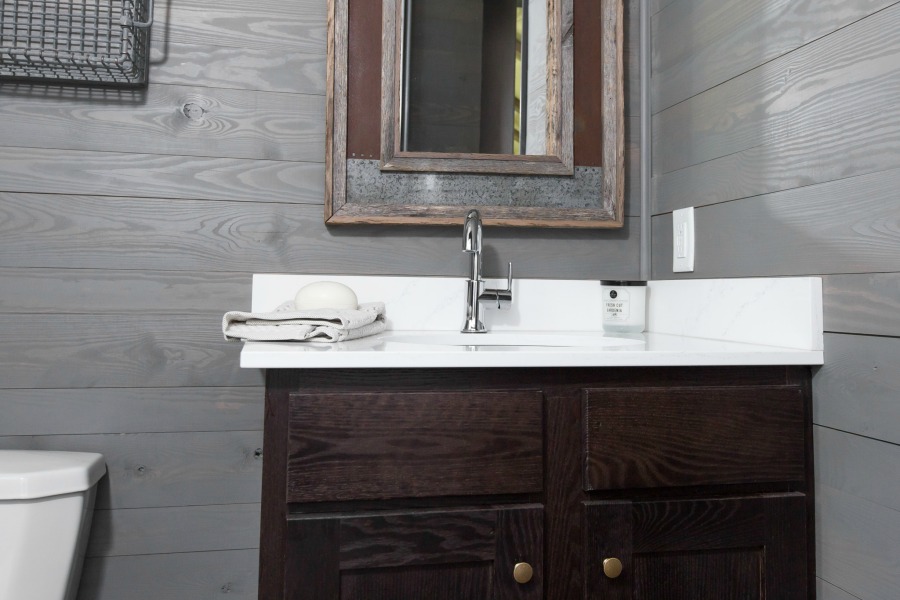 Bathroom vanity in tiny house designed by Jeffrey Dungan, an exquisitely crafted luxurious Low Country style Designer Cottage at The Retreat at Oakstone.
