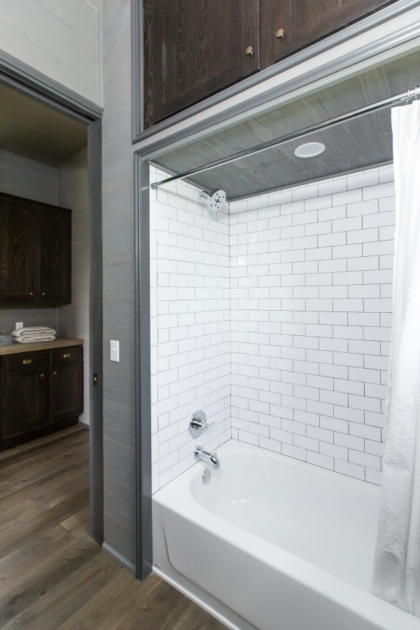 Subway tiled bath area in tiny house designed by Jeffrey Dungan, an exquisitely crafted luxurious Low Country style Designer Cottage at The Retreat at Oakstone.