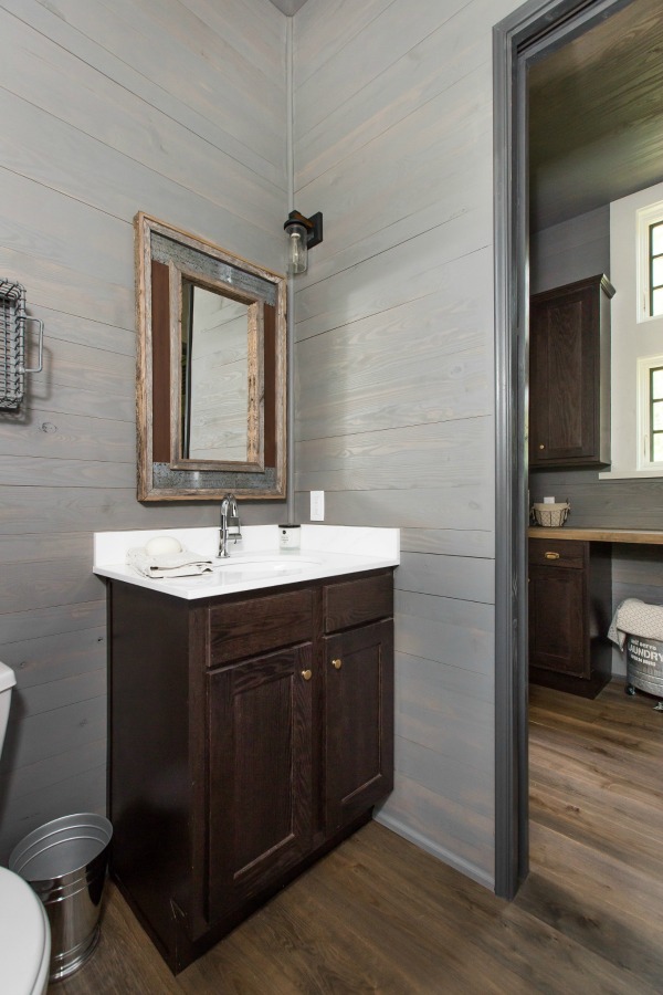 View of laundry room from bathroom in tiny house designed by Jeffrey Dungan, an exquisitely crafted luxurious Low Country style Designer Cottage at The Retreat at Oakstone.