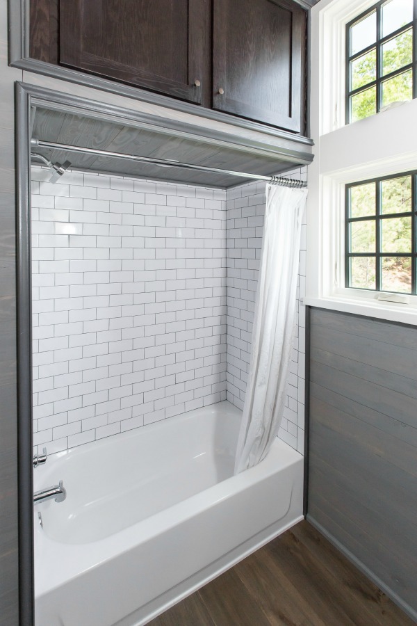 Bathroom with tiled tub area in tiny house designed by Jeffrey Dungan, an exquisitely crafted luxurious Low Country style Designer Cottage at The Retreat at Oakstone.