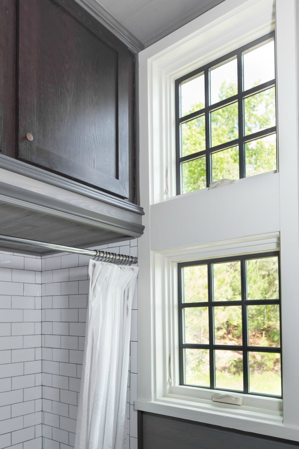 Light flooded bathroom with high ceilings in tiny house designed by Jeffrey Dungan, an exquisitely crafted luxurious Low Country style Designer Cottage at The Retreat at Oakstone.