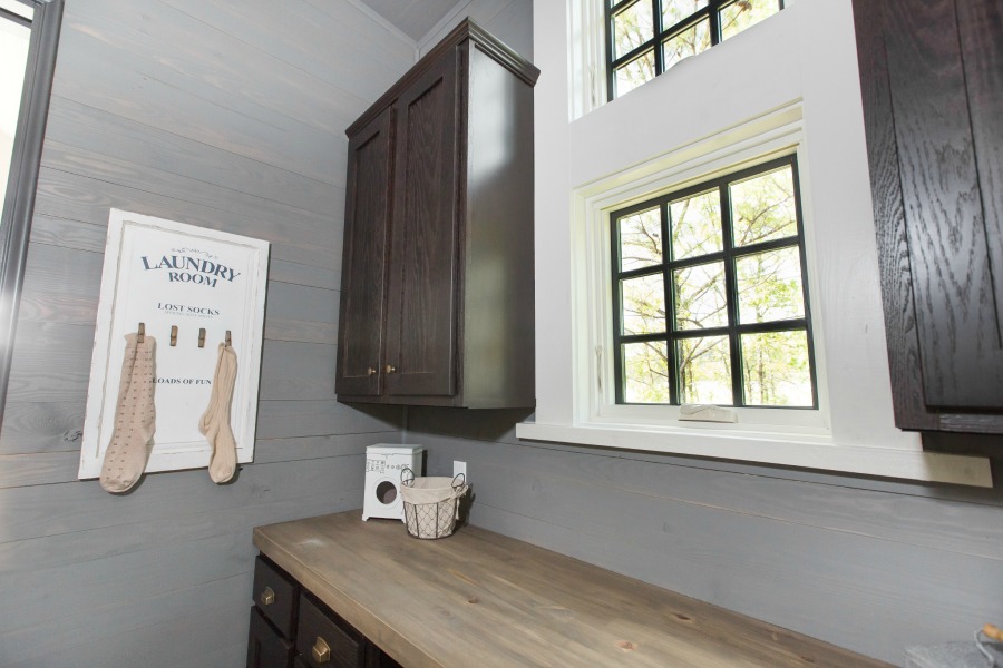 Laundry room in tiny house designed by Jeffrey Dungan, an exquisitely crafted luxurious Low Country style Designer Cottage at The Retreat at Oakstone.