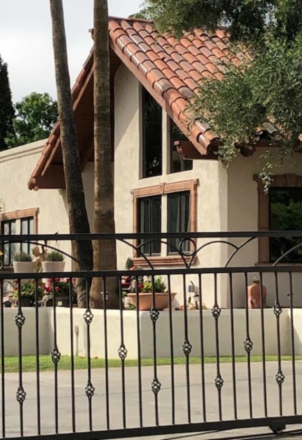 Beautiful house exterior with wrought iron gate - Hello Lovely Studio.