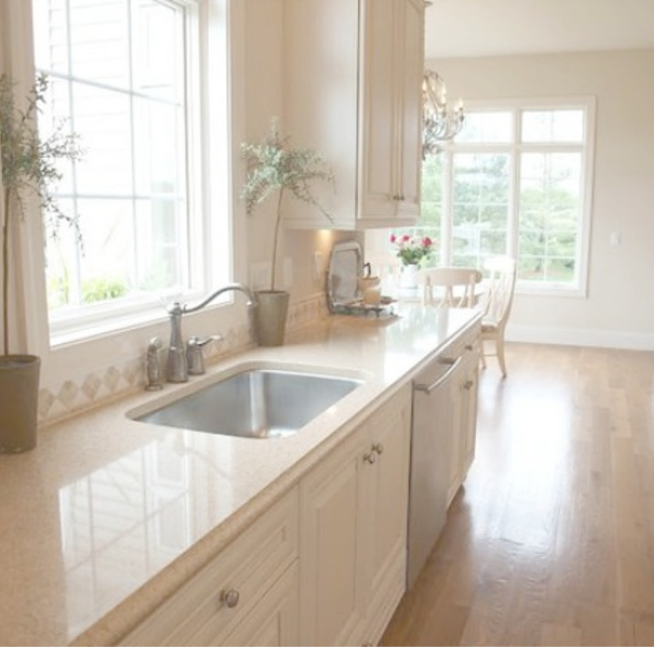 Benjamin Moore White Sand paint color in serene monochromatic French country kitchen - Hello Lovely Studio. Come discover warm white paint colors! #paintcolors #benjaminmoore #whitesand #whitepaintcolors #warmwhitepaints