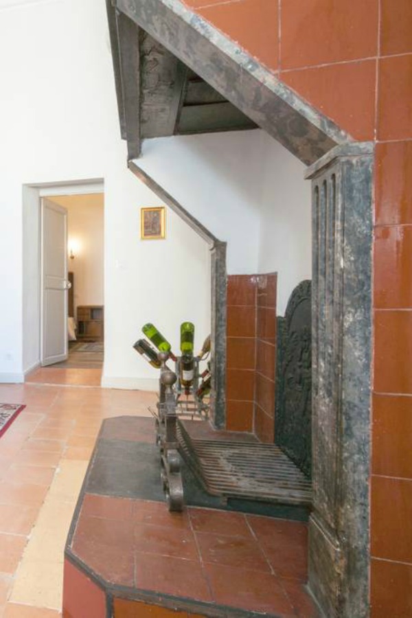 Detail of Old World fireplace in kitchen. Classic French apartment with luxurious interiors has been fully renovated to high standards in Carcassonne, France and is available to rent - L'ancienne Tannerie.