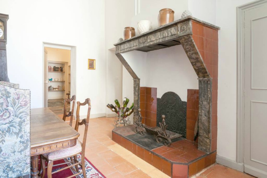 Kitchen fireplace. Classic French apartment with luxurious interiors has been fully renovated to high standards in Carcassonne, France and is available to rent - L'ancienne Tannerie.