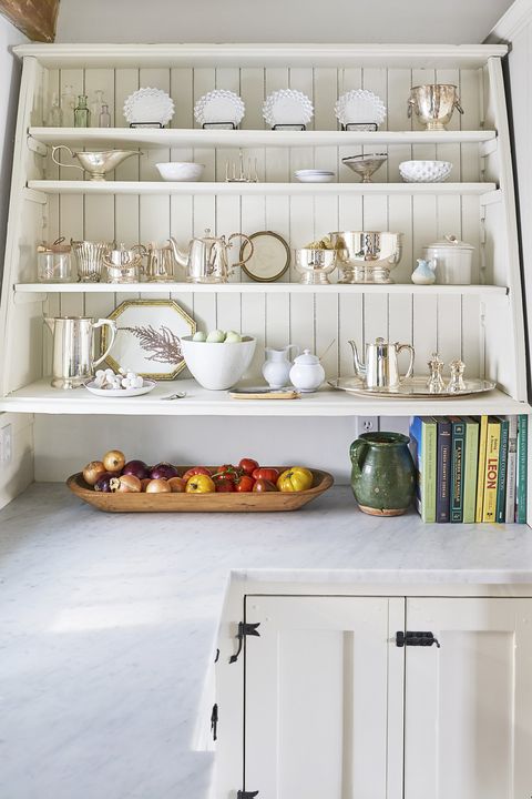 Gorgeous country kitchen with shelves of ironstone against beadboard - this is the Connecticut farmhouse of OKL president Debbie Propst - photo by Country Living.