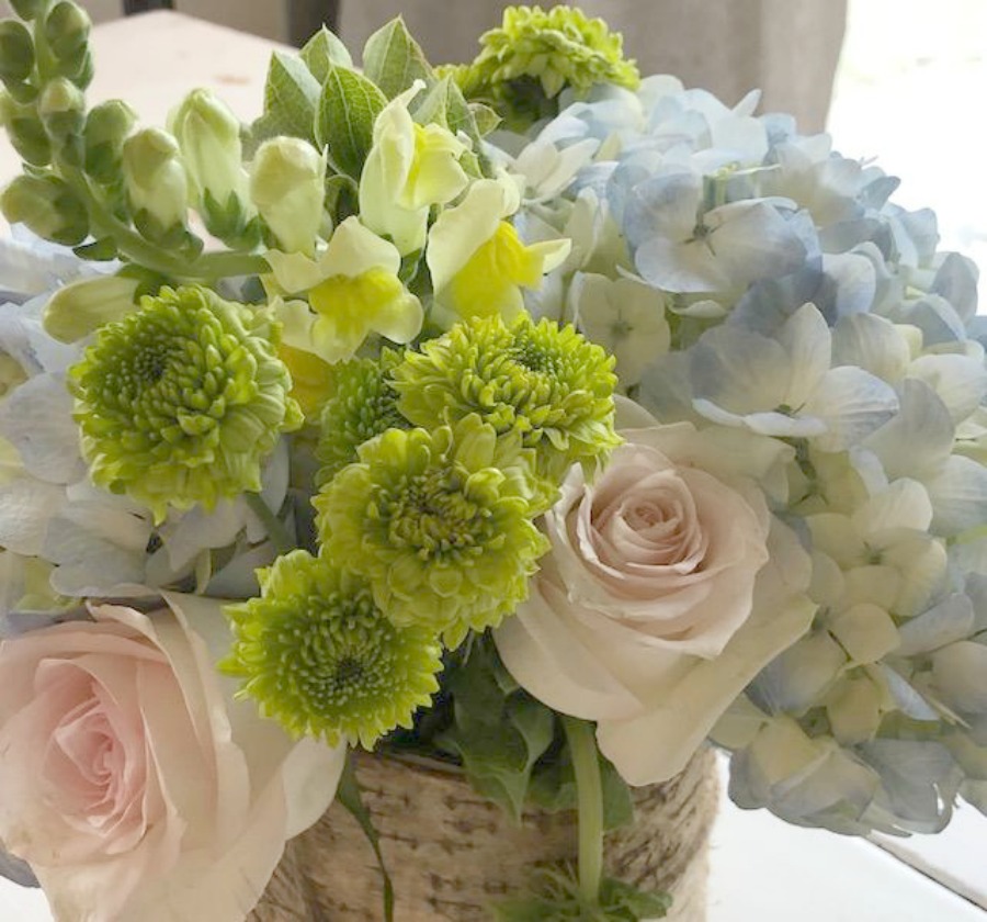 Spring floral arrangement on my kitchen table with blue hydrangea, blush pink roses, and greenery. Hello Lovely Studio.