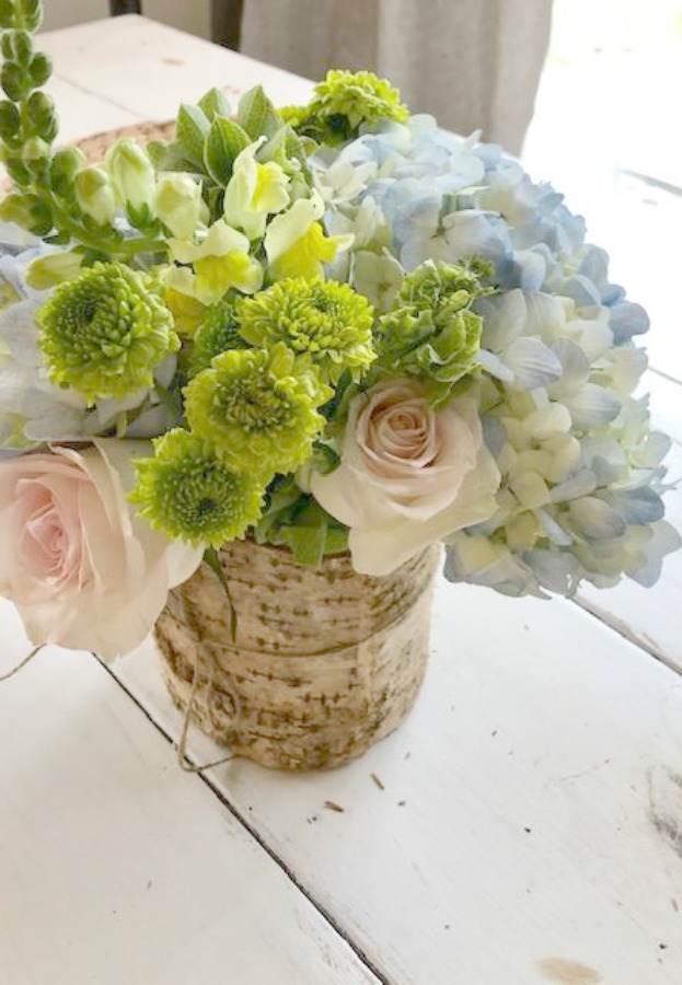 Spring floral arrangement on my kitchen table with blue hydrangea, blush pink roses, and greenery. Hello Lovely Studio.