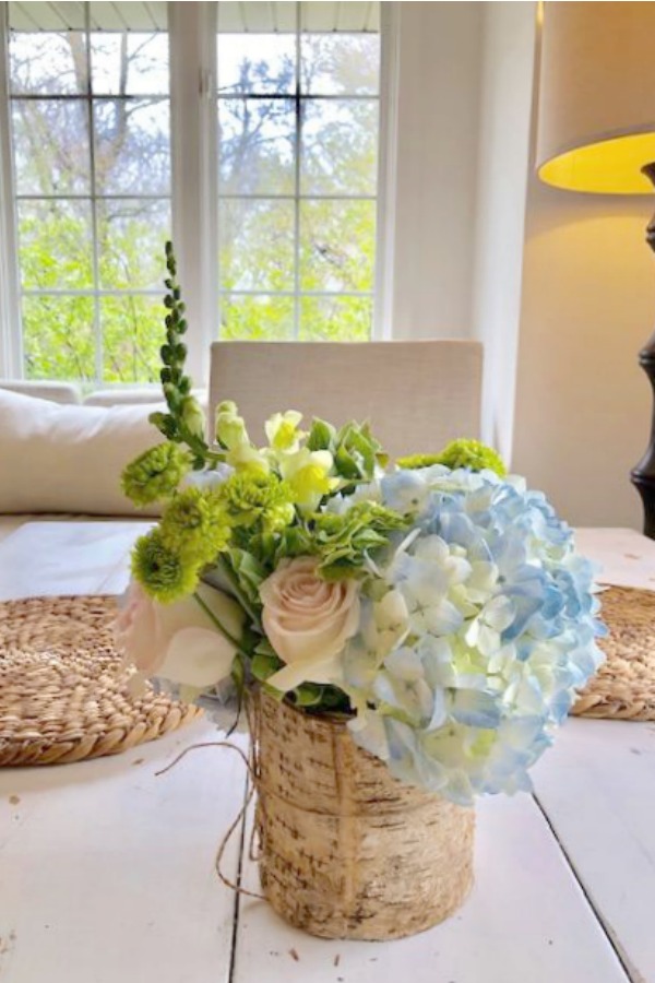 Spring floral arrangement on my kitchen table with blue hydrangea, blush pink roses, and greenery. Hello Lovely Studio.