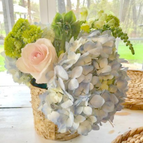 Spring floral arrangement on my kitchen table with blue hydrangea, blush pink roses, and greenery. Hello Lovely Studio.