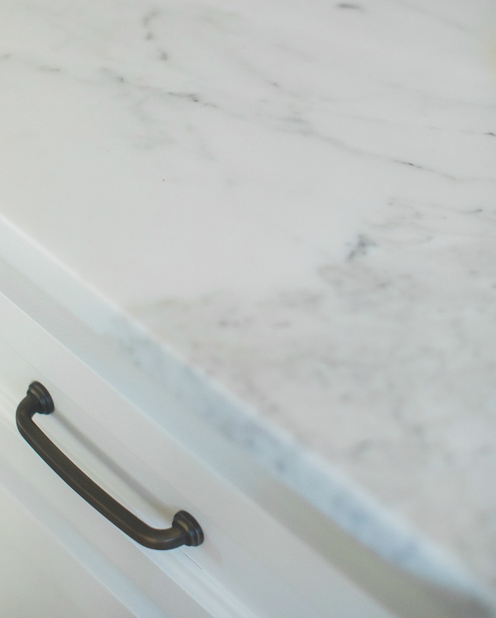 Detail of honed arabescato marble countertop in French country kitchen by Brit Jones.