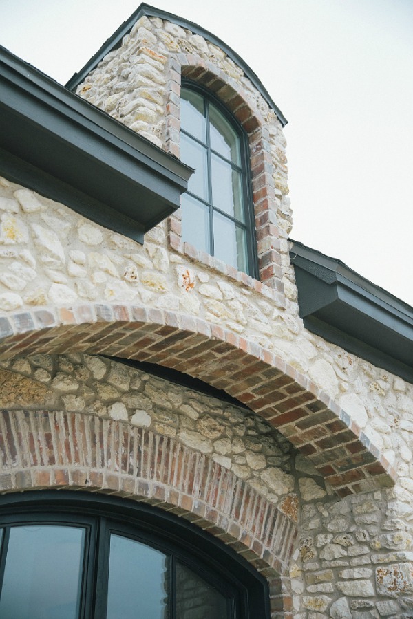 Detail of brick and stone on French country new house exterior. Brit Jones photography.