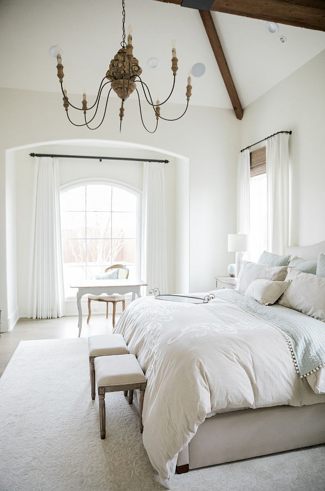 Airy, lofty, and elegant French country farmhouse bedroom with arches, desk, and bench. Brit Jones Design. See 18 Inspiring Country French Bedroom Decor Ideas!