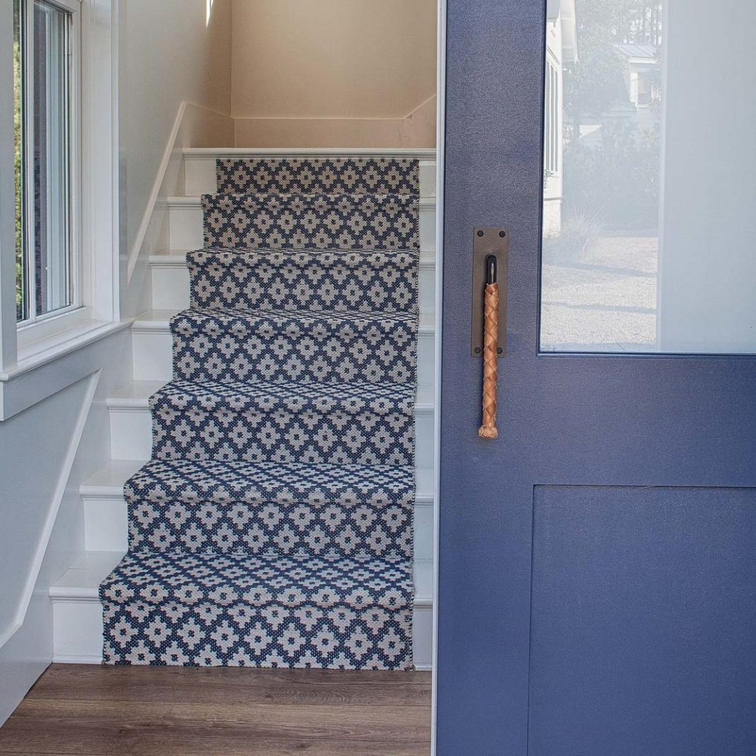 Blue patterned stair runner and blue door in a coastal cottage by Lisa Furey. #bluedecor #bluepaint #bluedoor #bluecarpet #stairrunner #coastalstyle