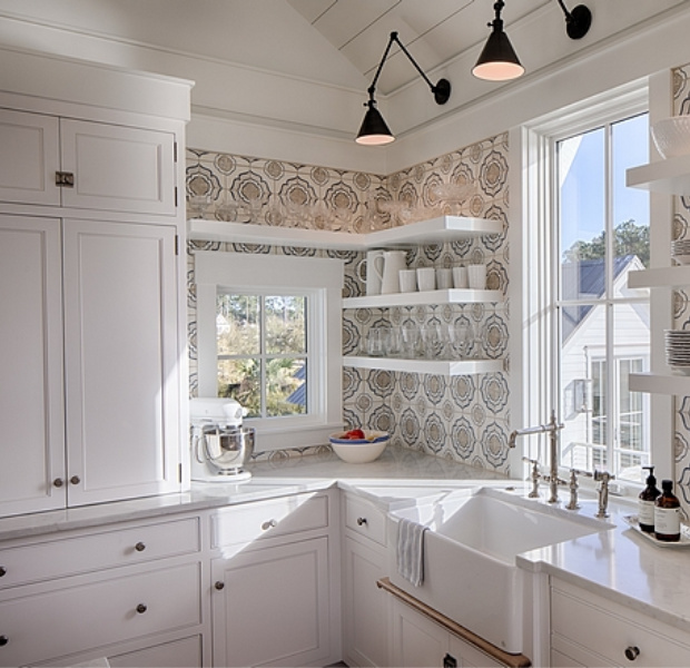 White coastal cottage kitchen with floating shelves, Shaker cabinets, white oak, and cement tile backsplash with blue accents. Lisa Furey. #coastalkitchen #whitekitchens #kitchendesign #modernfarmhouse #coastalcottage #cottagekitchen #floatingshelves #farmsink #shiplap