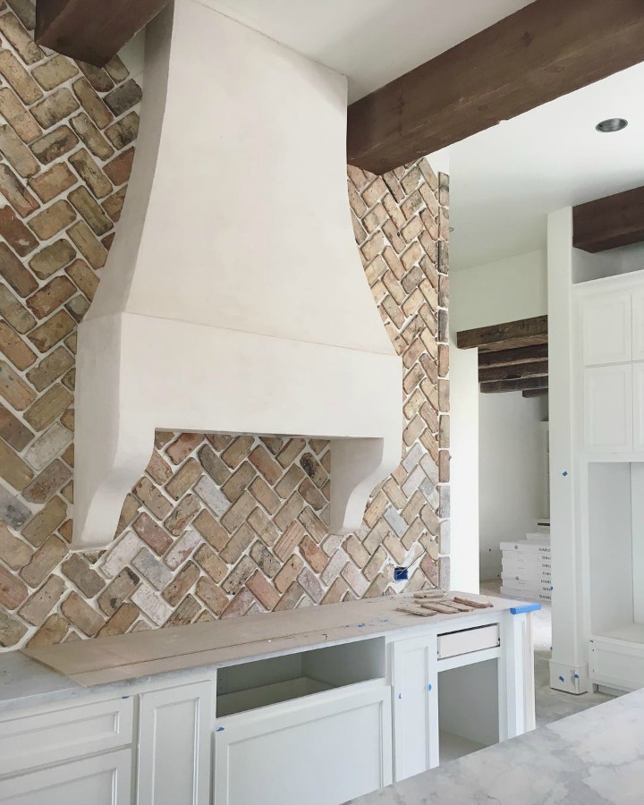 Under construction French country farmhouse kitchen with reclaimed Chicago brick ungrouted. Brit Jones Design.