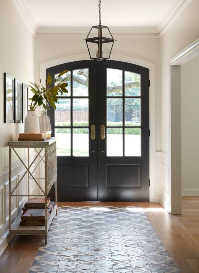 Fixer Upper Club House episode featured this stunning French farmhouse foyer with beautiful arched black doors and encaustic tile flooring. #theclubhouse #fixerupper #entryway #frenchcountry #interiordesign #joannagaines