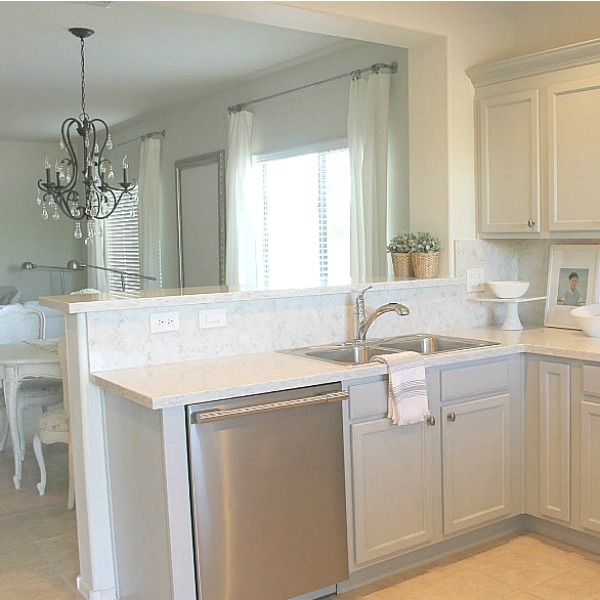 Serene kitchen in Arizona with light grey blue cabinets and stainless appliances. Hello Lovely Studio.