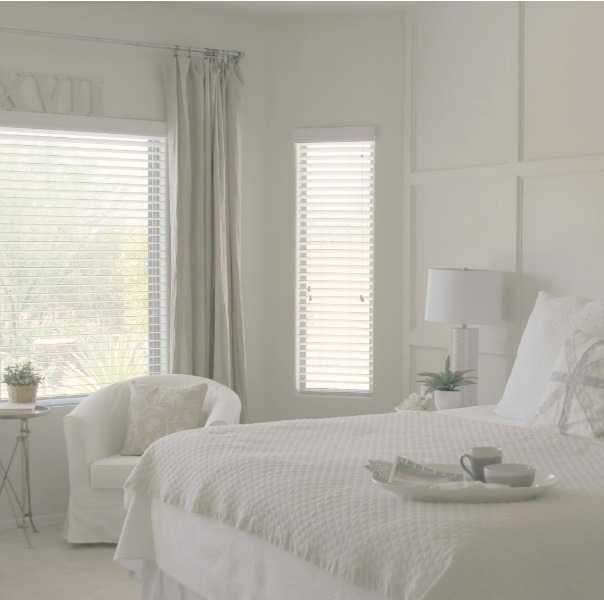 Serene and sunny white bedroom in Arizona with board and batten panel wall and sliding modern barn door. Hello Lovely Studio.