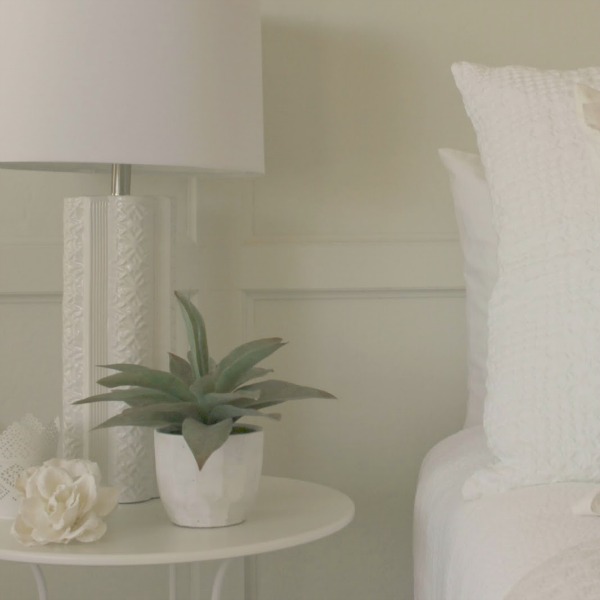 Serene and sunny white bedroom in Arizona with board and batten panel wall and sliding modern barn door. Hello Lovely Studio.