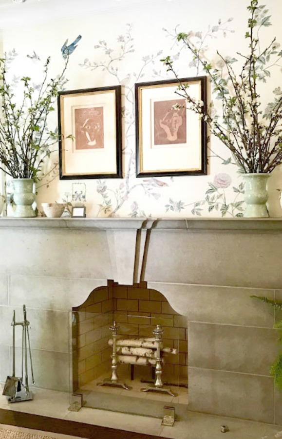 Living room with geometric limestone mantel. Interior Design: Beth Webb. Wallpaper: Iksel for Schumacher; Xanadu Landscape in Bone. 2018 Southeastern Designer Showhouse in Atlanta. Photo: Sherry Hart.