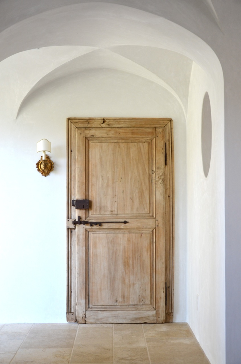 Patina Farm laundry room door and vintage sconce - design by Brooke Giannetti.