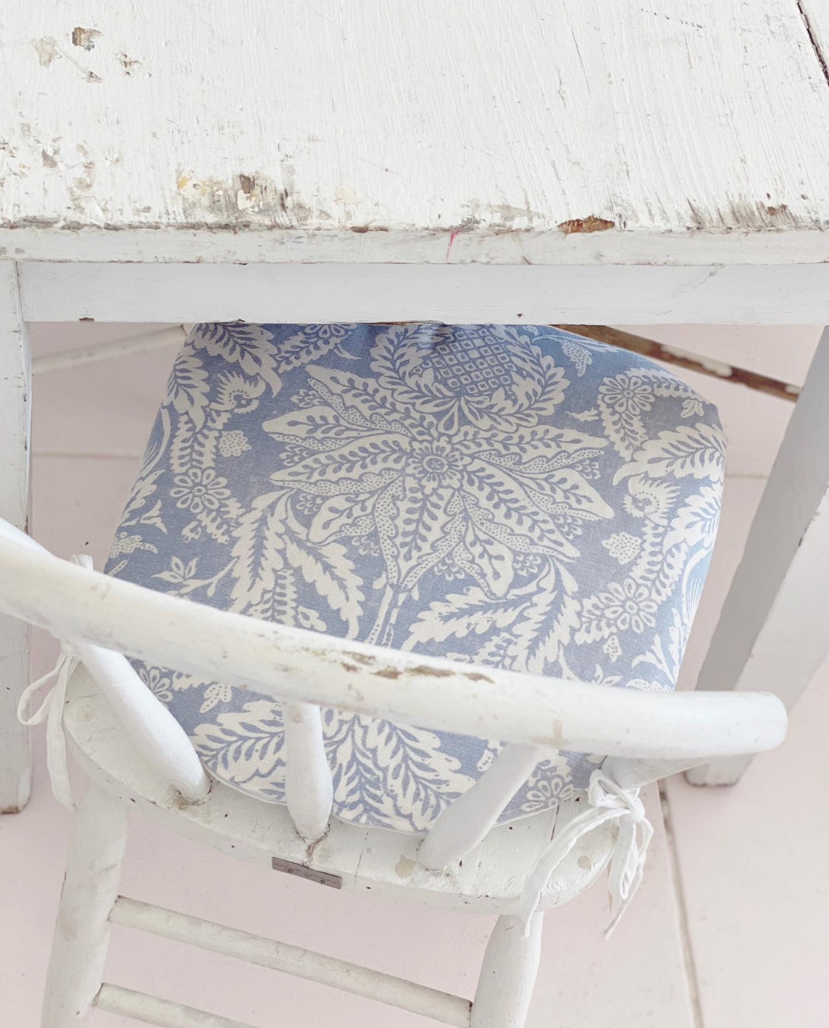 Rachel Ashwell Official Shabby Chic - blue cushion on a chippy white vintage desk chair. #officialshabbychic