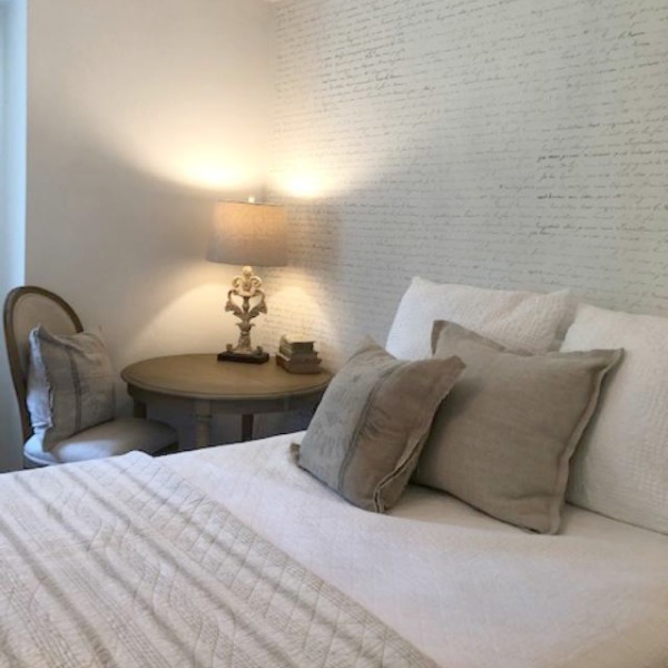 DIY Chic French Script Stenciled Accent Wall. Country French farmhouse style bedroom with French script stenciled wall by Hello Lovely Studio. #frenchcountry #frenchfarmhouse #frenchscript #diy #stenciledwall