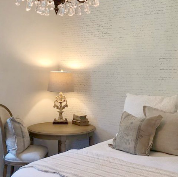 DIY Chic French Script Stenciled Accent Wall. Country French farmhouse style bedroom with French script stenciled wall by Hello Lovely Studio. #frenchcountry #frenchfarmhouse #frenchscript #diy #stenciledwall