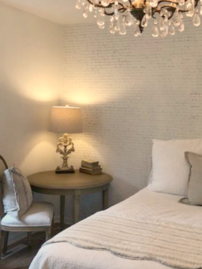 DIY Chic French Script Stenciled Accent Wall. Country French farmhouse style bedroom with French script stenciled wall by Hello Lovely Studio. #frenchcountry #frenchfarmhouse #frenchscript #diy #stenciledwall