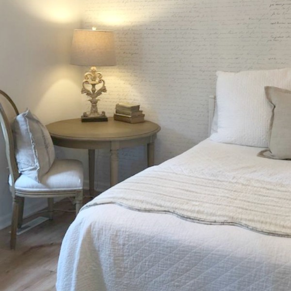 DIY Chic French Script Stenciled Accent Wall. Country French farmhouse style bedroom with French script stenciled wall by Hello Lovely Studio. #frenchcountry #frenchfarmhouse #frenchscript #diy #stenciledwall