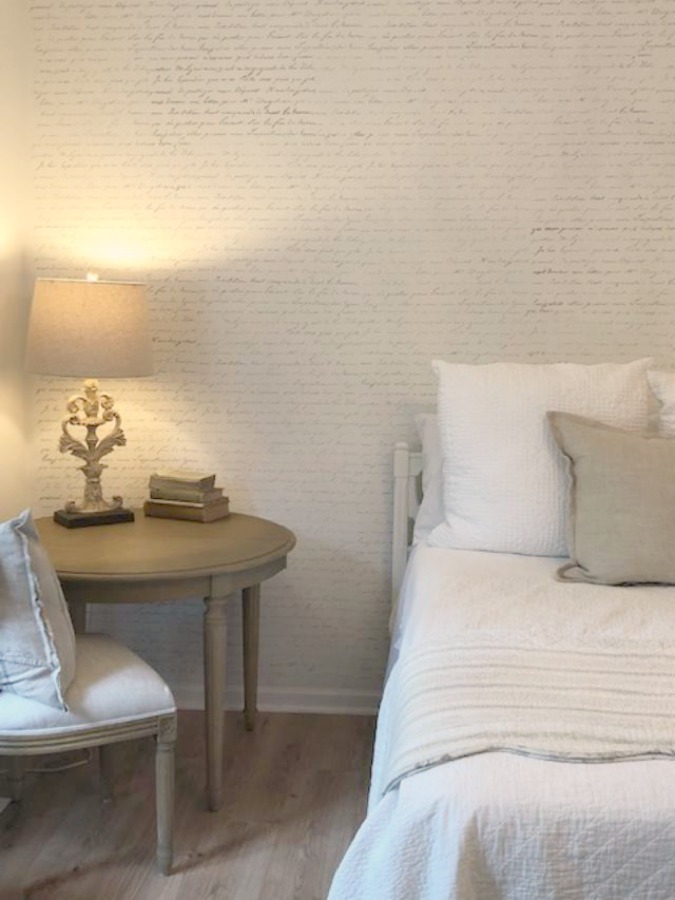 DIY Chic French Script Stenciled Accent Wall. Country French farmhouse style bedroom with French script stenciled wall by Hello Lovely Studio. #frenchcountry #frenchfarmhouse #frenchscript #diy #stenciledwall